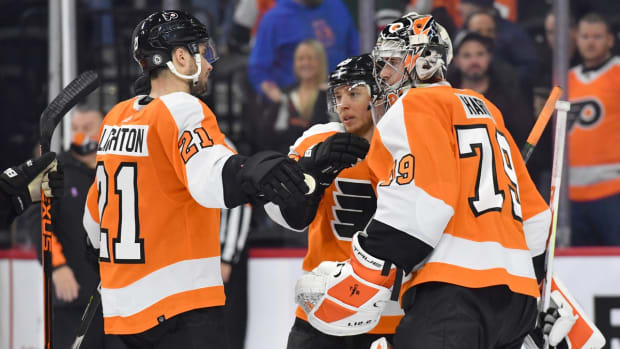 Dec 14, 2021; Philadelphia, Pennsylvania, USA; Philadelphia Flyers left wing Scott Laughton (21) , right wing Cam Atkinson (89) and goaltender Carter Hart (79) celebrate their win against the New Jersey Devils at Wells Fargo Center. Mandatory Credit: Eric Hartline-USA TODAY Sports